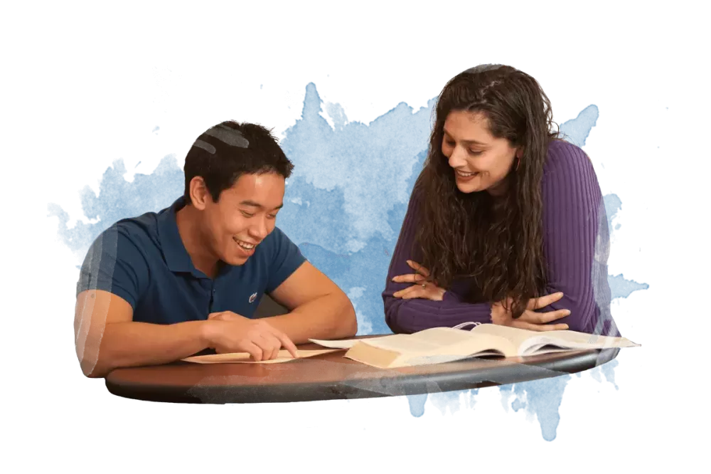 Two people discussing studies while looking at notes