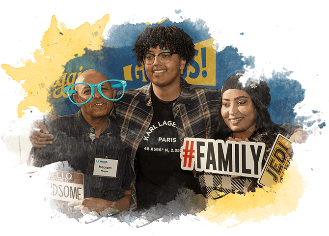 A student stands with their family to pose for a picture at UC Davis Welcome